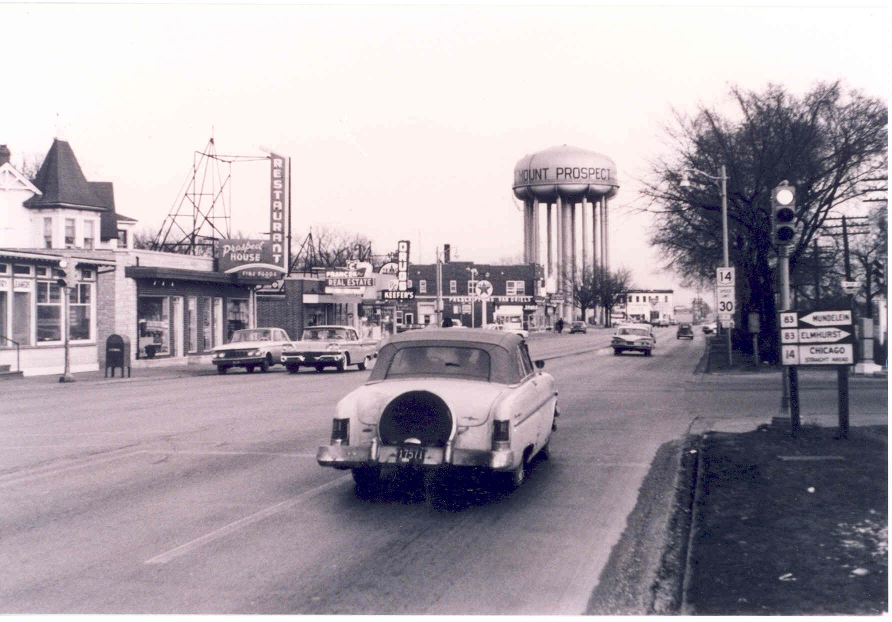 A nostalgic image of a car traveling on a street